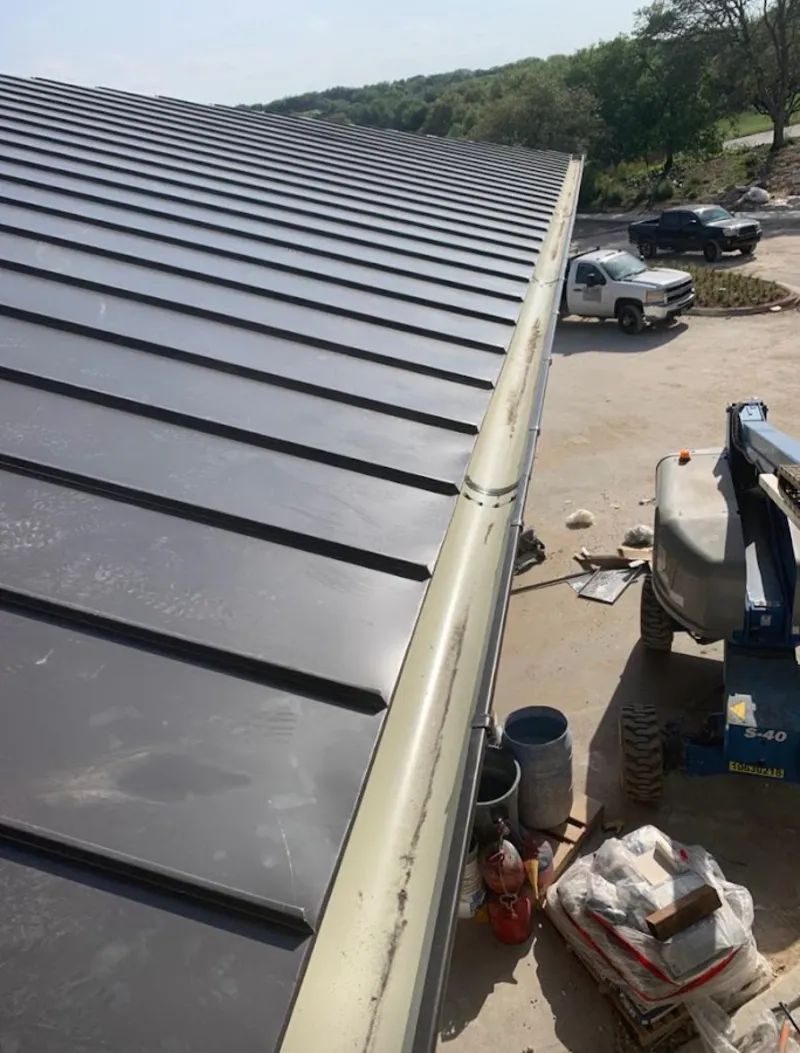 Standing seam panel and gutter detail on a metal roofing jobsite in Hereford